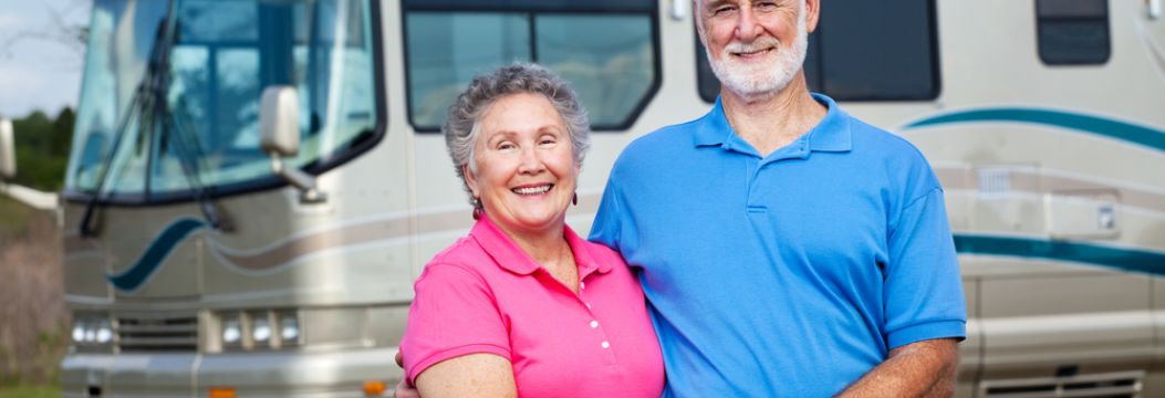 Couple standing in front of their RV