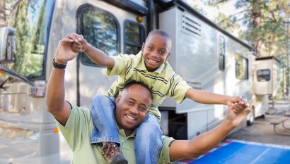 Dad and son in front of their RV