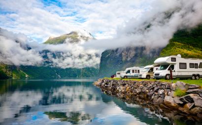 RVs beside a mountain lake