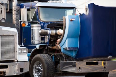 Semi truck with its hood open for maintenance